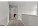 Carpeted hallway with white walls leads to bedrooms in this well-maintained home at 1756 Beckworth Ln, Hampton, GA 30228