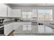 Close up on white kitchen island and countertops with stainless steel dishwasher at 1756 Beckworth Ln, Hampton, GA 30228