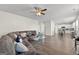 Open living room with a large sectional, ceiling fan, and view into the kitchen at 1756 Beckworth Ln, Hampton, GA 30228