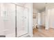 Bright bathroom featuring a glass enclosed shower with built in shelves and wood look flooring at 988 Sutherland Lane # 33, Lawrenceville, GA 30043