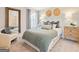 Bright bedroom features a cozy queen bed, a neutral color palette, and a comfortable armchair at 988 Sutherland Lane # 33, Lawrenceville, GA 30043