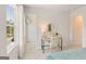 Bedroom with a cozy desk, adjacent walk-in closet, and a window with a view of the outdoors at 988 Sutherland Lane # 33, Lawrenceville, GA 30043