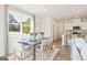 Sunlit dining room with a wood table, stylish chairs, and an open view into the modern kitchen at 988 Sutherland Lane # 33, Lawrenceville, GA 30043