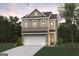 Charming two-story home featuring a brick-and-siding facade, attached garage, and a well-manicured front lawn at 988 Sutherland Lane # 33, Lawrenceville, GA 30043