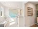 Sunlit hallway with neutral paint, large art piece, and adjacent closet for storage at 988 Sutherland Lane # 33, Lawrenceville, GA 30043