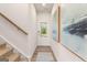 Bright entryway featuring a staircase, a front door with glass panel, and neutral walls at 988 Sutherland Lane # 33, Lawrenceville, GA 30043
