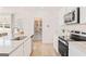 Bright kitchen with stainless steel appliances and granite counters, walk in pantry in background at 988 Sutherland Lane # 33, Lawrenceville, GA 30043