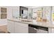 Kitchen island with white cabinetry, stainless steel dishwasher, and granite countertops at 988 Sutherland Lane # 33, Lawrenceville, GA 30043