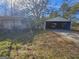 A view of the home's detached garage that includes space for parking and storage at 4284 Highway 81 S, Covington, GA 30016