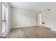 Bright bedroom featuring light hardwood floors, neutral walls, and natural light from a window at 510 River Run Dr, Atlanta, GA 30350