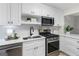 Bright kitchen featuring white cabinets, stainless steel appliances, and quartz countertops at 510 River Run Dr, Atlanta, GA 30350