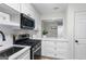 Open-concept kitchen featuring white cabinets, stainless steel appliances, and quartz countertops at 510 River Run Dr, Atlanta, GA 30350