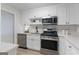 Bright kitchen featuring white cabinets, stainless steel appliances, and quartz countertops at 510 River Run Dr, Atlanta, GA 30350