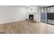 Cozy living room with a fireplace, hardwood floors, and sliding glass door to the outside at 510 River Run Dr, Atlanta, GA 30350