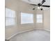 Sun-filled bedroom featuring neutral colored walls, three large windows, and modern ceiling fan at 238 Harvest Trce, Sharpsburg, GA 30277