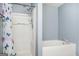 Bathroom with a shower and tub, complemented by a blue wall at 6517 Snowbird Ln, Douglasville, GA 30134