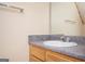 Bathroom features a sink with wooden cabinets and granite countertops at 6517 Snowbird Ln, Douglasville, GA 30134
