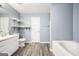 Bathroom featuring modern wood-look floors, a white vanity and a tub at 6517 Snowbird Ln, Douglasville, GA 30134