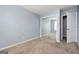 Spacious bedroom with soft blue walls, neutral carpet, and a mirrored closet at 6517 Snowbird Ln, Douglasville, GA 30134