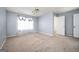 View of a carpeted bedroom with ceiling fan and sheer floral curtains at 6517 Snowbird Ln, Douglasville, GA 30134