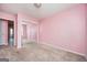 Bedroom with pink walls and carpeted floors, complete with closet at 6517 Snowbird Ln, Douglasville, GA 30134