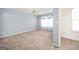 View of a carpeted bedroom with ceiling fan and sheer floral curtains at 6517 Snowbird Ln, Douglasville, GA 30134