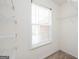 View of a walk-in closet with carpet, wire shelves and a window with blinds at 6517 Snowbird Ln, Douglasville, GA 30134