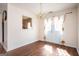 Charming dining space with wood floors, decorative lighting, and a view into the kitchen area at 6517 Snowbird Ln, Douglasville, GA 30134