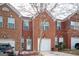 Lovely brick townhome with well-manicured lawn, one-car garage, decorated door, and wintery curb appeal at 6517 Snowbird Ln, Douglasville, GA 30134