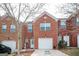 Charming brick townhome with a one car garage and a well maintained front yard and inviting front door at 6517 Snowbird Ln, Douglasville, GA 30134