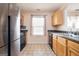 Kitchen featuring stainless steel appliances, wood cabinets, and a window overlooking the sink at 6517 Snowbird Ln, Douglasville, GA 30134