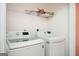 Laundry room featuring modern LG washer and dryer with storage shelf above at 6517 Snowbird Ln, Douglasville, GA 30134