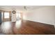 Spacious living room with dark wood flooring and ample natural light from the adjoining kitchen and patio at 6517 Snowbird Ln, Douglasville, GA 30134