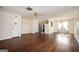 Expansive living room featuring wood floors, a ceiling fan, and open access to the kitchen and backyard patio at 6517 Snowbird Ln, Douglasville, GA 30134