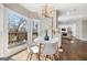 Sunny breakfast nook with large windows offering beautiful views, white table and chairs, and hardwood floors at 809 Byrnwyck Ne Rd, Brookhaven, GA 30319