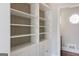 Hallway featuring custom built-in shelving with cabinets, offering ample storage space at 809 Byrnwyck Ne Rd, Brookhaven, GA 30319