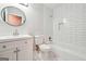 Updated bathroom with white subway tile in shower, a round mirror, and a modern vanity sink at 1015 Chapman Ln, Stone Mountain, GA 30088