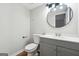 Neutral half bathroom with gray vanity at 1015 Chapman Ln, Stone Mountain, GA 30088