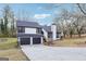 Two-story home featuring a gray roof, two car garage, concrete driveway and well manicured lawn at 1015 Chapman Ln, Stone Mountain, GA 30088