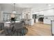 Open kitchen with white cabinets, stainless steel appliances, breakfast bar, and adjacent dining area at 1015 Chapman Ln, Stone Mountain, GA 30088