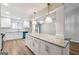 Bright, open kitchen with a large center island featuring granite countertops and modern pendant lighting at 1015 Chapman Ln, Stone Mountain, GA 30088