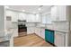 Updated kitchen with white cabinets, granite counters, stainless steel appliances and a modern backsplash at 1015 Chapman Ln, Stone Mountain, GA 30088
