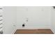 Empty laundry room with laminate flooring and a white wall, ready for appliances at 1015 Chapman Ln, Stone Mountain, GA 30088