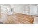 Open-concept living area with hardwood floors and direct view into updated kitchen space at 1015 Chapman Ln, Stone Mountain, GA 30088