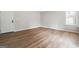 Open-concept living room with new wood flooring, white trim, and abundant natural light at 1015 Chapman Ln, Stone Mountain, GA 30088