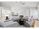 Bright, airy living room with vaulted ceilings, modern furniture, and seamless transition to dining space at 1015 Chapman Ln, Stone Mountain, GA 30088