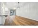 Open-concept living area with hardwood floors and direct view into updated kitchen space at 1015 Chapman Ln, Stone Mountain, GA 30088