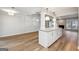 Open-concept living space with hardwood floors and center island with granite countertops at 1015 Chapman Ln, Stone Mountain, GA 30088