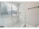 Updated shower with marble-look tile and glass enclosure at 1015 Chapman Ln, Stone Mountain, GA 30088