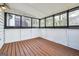 Enclosed sunroom with wood floors and multiple windows provides natural light at 1015 Chapman Ln, Stone Mountain, GA 30088